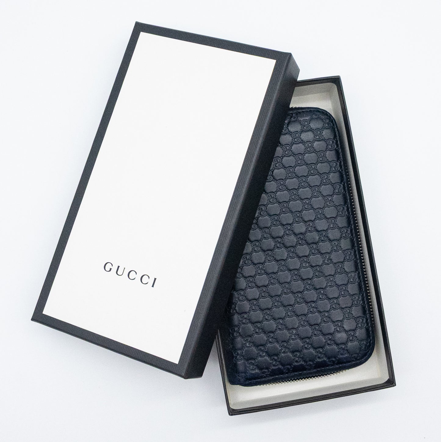Gucci GG Embossed Navy Blue Zip-Around Wallet